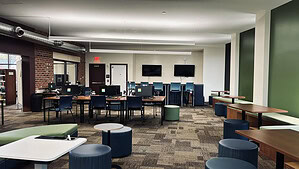 Image of the teen room at the Waverly Public LIbrary. Tables and chairs along with footrests.